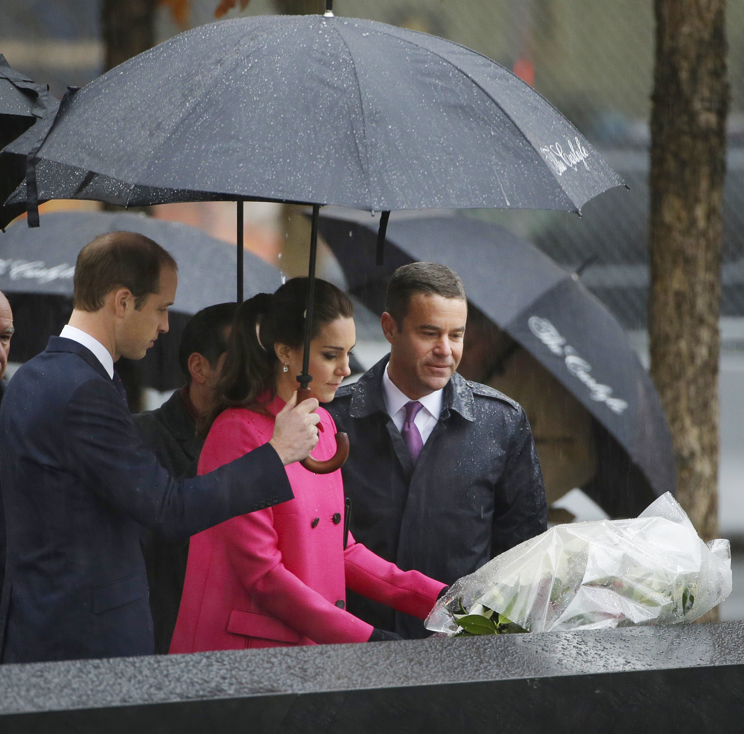 PHOTO: Britain's Prince William, left, and Joe Daniels, president of the 9/11 Memorial, right, look on, as Kate, Duchess of Cambridge, lays flowers at the edge of a memorial pool at the National Sept.11 Memorial in New York,  Dec. 9, 2014. 