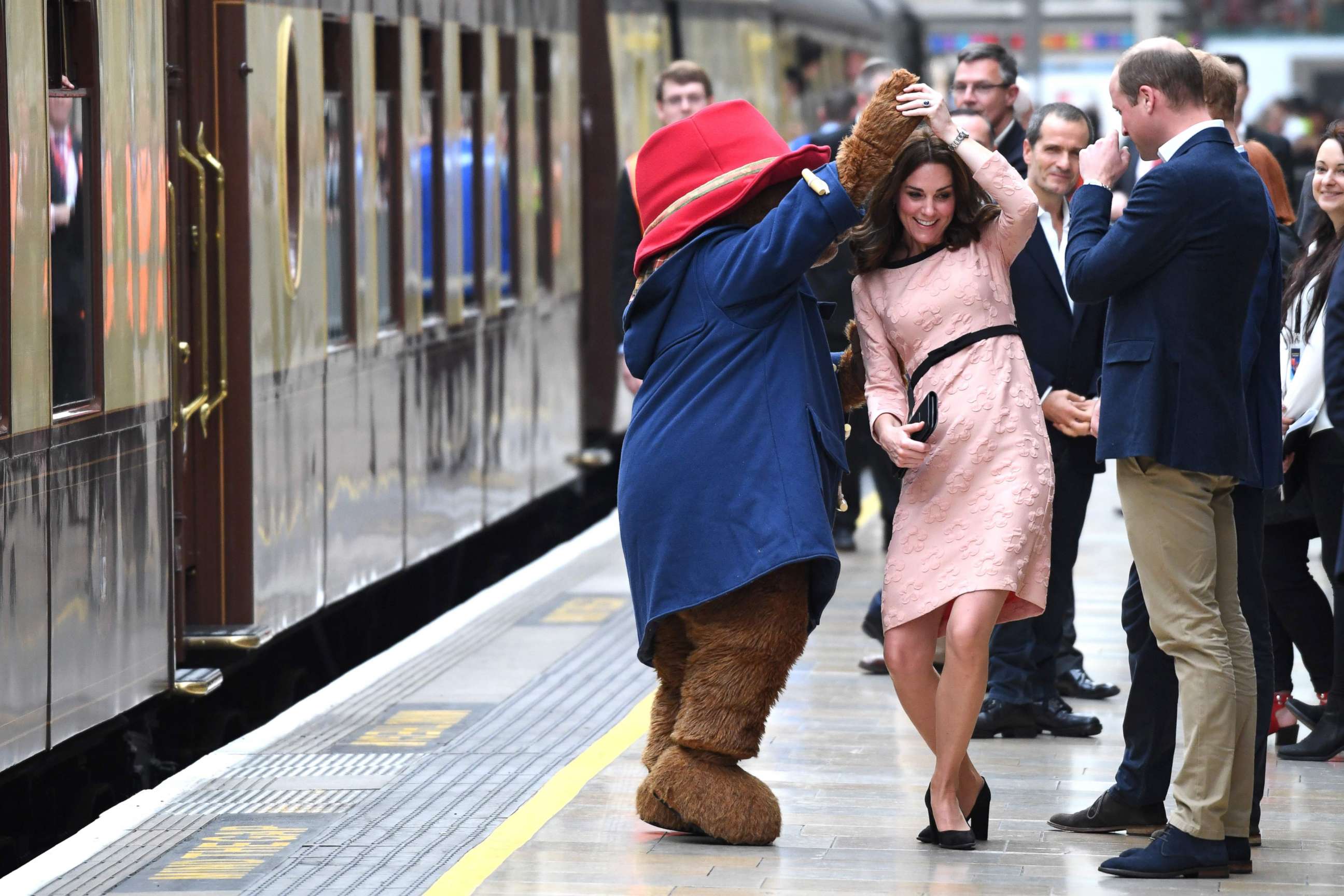 PHOTO: Britain's Catherine, Duchess of Cambridge, dances with a person in a Paddington Bear outfit by her husband Britain's Prince William, Duke of Cambridge as they attend a charities forum event at Paddington train station in London, Oct. 16, 2017.