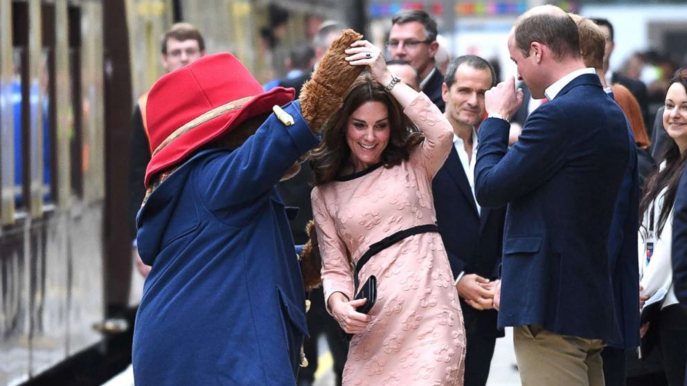 PHOTO: Britain's Catherine, Duchess of Cambridge, dances with a person in a Paddington Bear outfit by her husband Britain's Prince William, Duke of Cambridge as they attend a charities forum event at Paddington train station in London, Oct. 16, 2017.