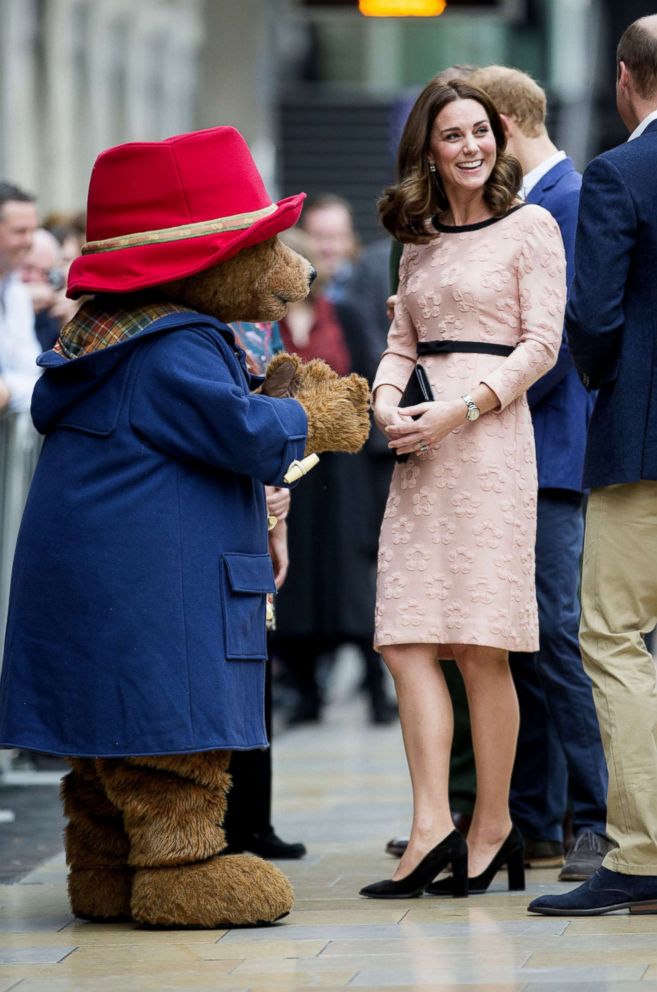 PHOTO: Britain's Catherine, Duchess of Cambridge, smiles with a person in a Paddington Bear outfit by her husband Britain's Prince William, Duke of Cambridge as they attend a charities forum event at Paddington train station in London, Oct. 16, 2017.