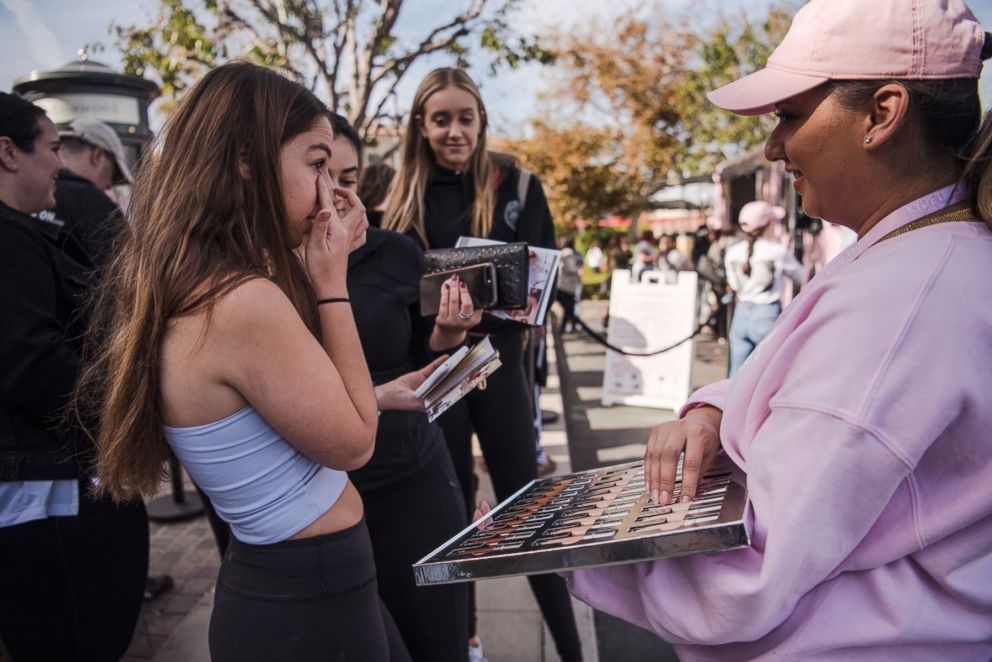   PHOTO: Young women try Kylie Cosmetics make-up samples at the Edwards Commons mall in Calabasas, California on December 9, 2017 