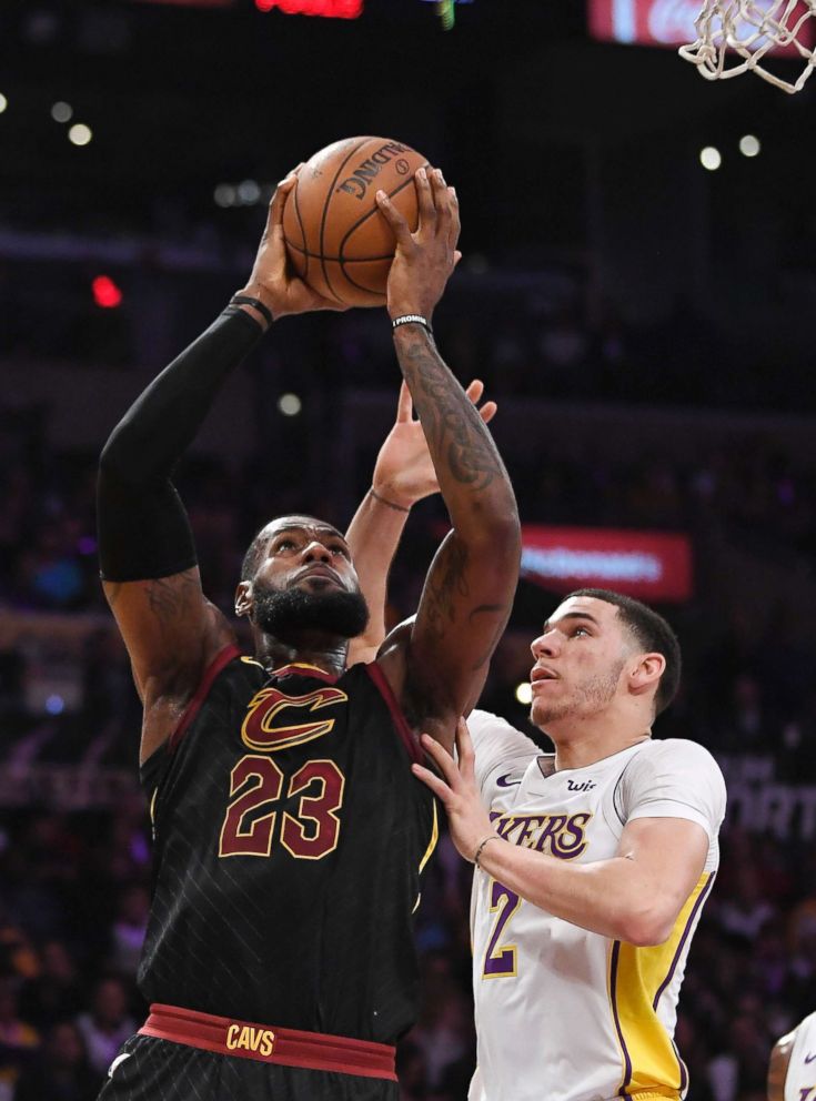 PHOTO: Cleveland Cavaliers, LeBron James, left, shoots as Los Angeles Lakers guard Lonzo Ball defends during the first half of an NBA basketball game, in Los Angeles.