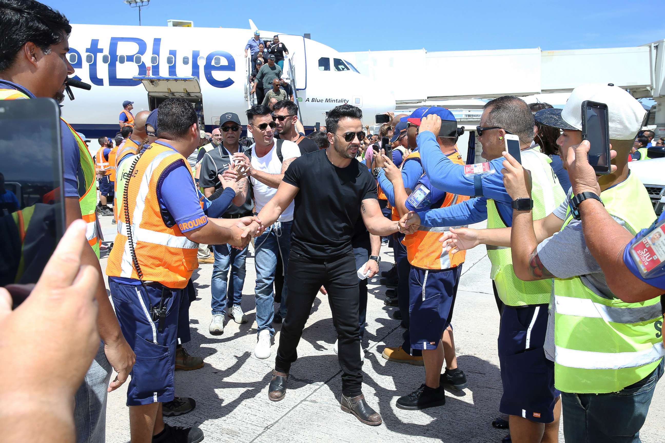PHOTO: Luis Fonsi, Ricky Martin and other Latin celebrities greet JetBlue crew members upon arrival at Luis Munoz Marin International Airport in San Juan, Puerto Rico, on, Oct. 2, 2017.