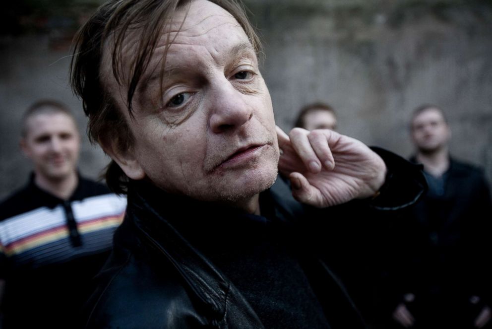 PHOTO: Manchester musician Mark E. Smith poses with other members of The Fall behind him in Salford, Manchester, March 18, 2011.