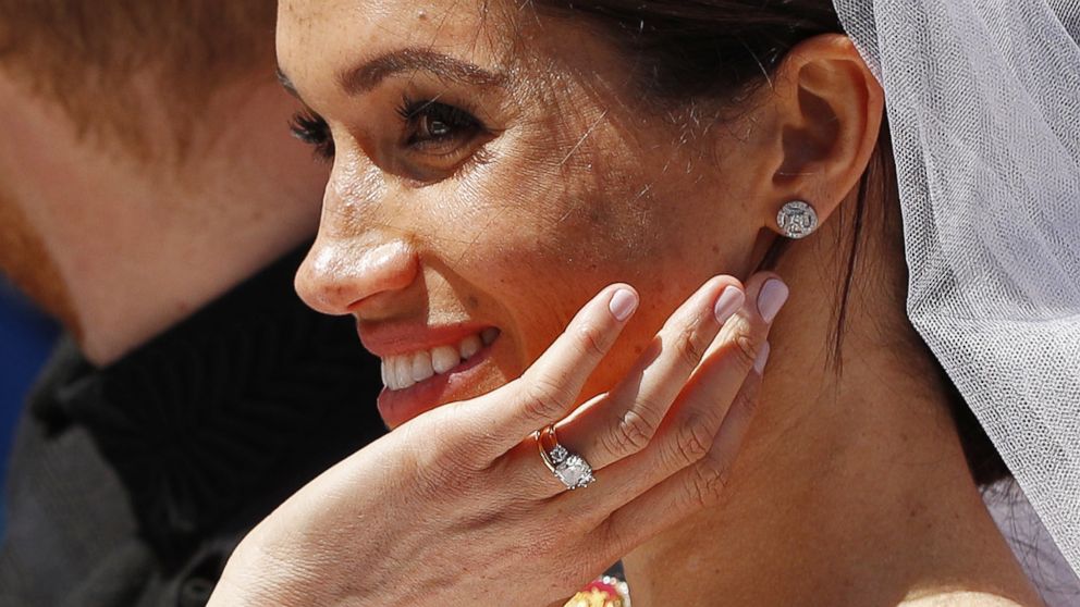 Britain's Prince Harry and his wife Meghan wave as they ride a horse-drawn carriage after their wedding ceremony at St George's Chapel in Windsor Castle in Windsor, England, May 19, 2018.