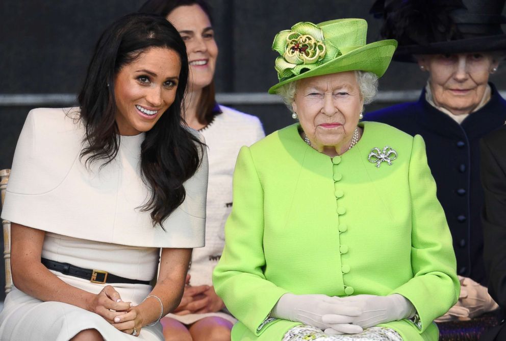 PHOTO: Meghan, Duchess of Sussex and Queen Elizabeth II laugh during a ceremony to open the new Mersey Gateway Bridge, June 14, 2018, in the town of Widnes in Halton, Cheshire, England.