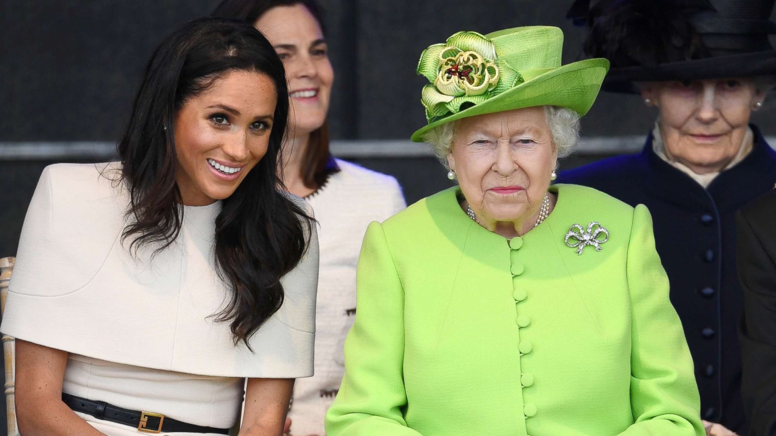 PHOTO: Meghan, Duchess of Sussex and Queen Elizabeth II laugh during a ceremony to open the new Mersey Gateway Bridge, June 14, 2018, in the town of Widnes in Halton, Cheshire, England.