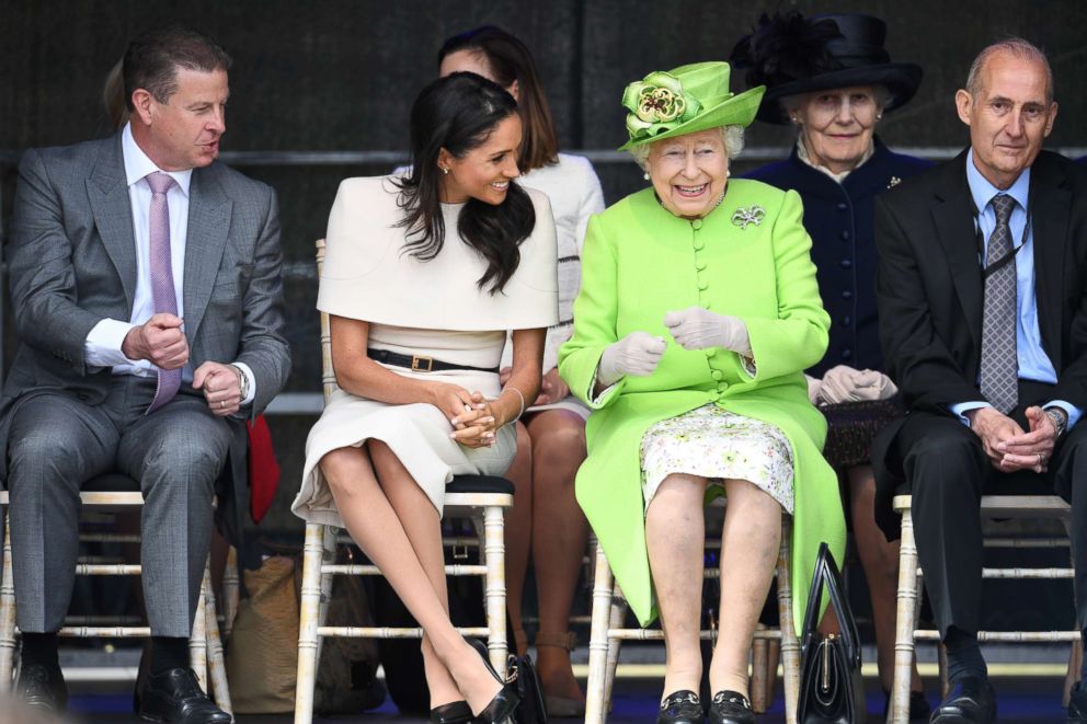 PHOTO: Meghan, Duchess of Sussex and Queen Elizabeth II laugh during a ceremony to open the new Mersey Gateway Bridge, June 14, 2018, in the town of Widnes in Halton, Cheshire, England.