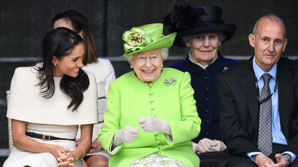 PHOTO: Meghan, Duchess of Sussex and Queen Elizabeth II laugh during a ceremony to open the new Mersey Gateway Bridge, June 14, 2018, in the town of Widnes in Halton, Cheshire, England.