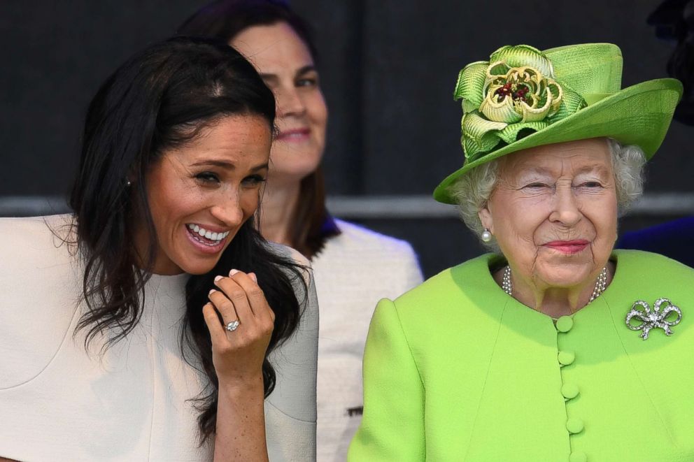 PHOTO: Meghan, Duchess of Sussex and Queen Elizabeth II laugh during a ceremony to open the new Mersey Gateway Bridge, June 14, 2018, in the town of Widnes in Halton, Cheshire, England.