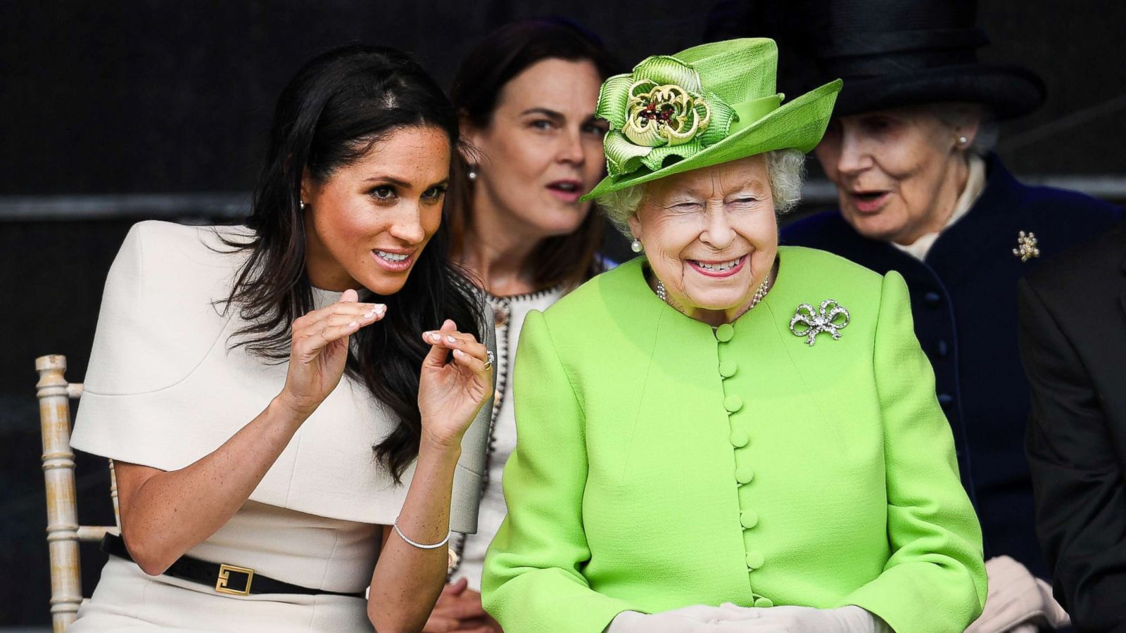 PHOTO: Meghan, Duchess of Sussex and Queen Elizabeth II laugh during a ceremony to open the new Mersey Gateway Bridge, June 14, 2018, in the town of Widnes in Halton, Cheshire, England.