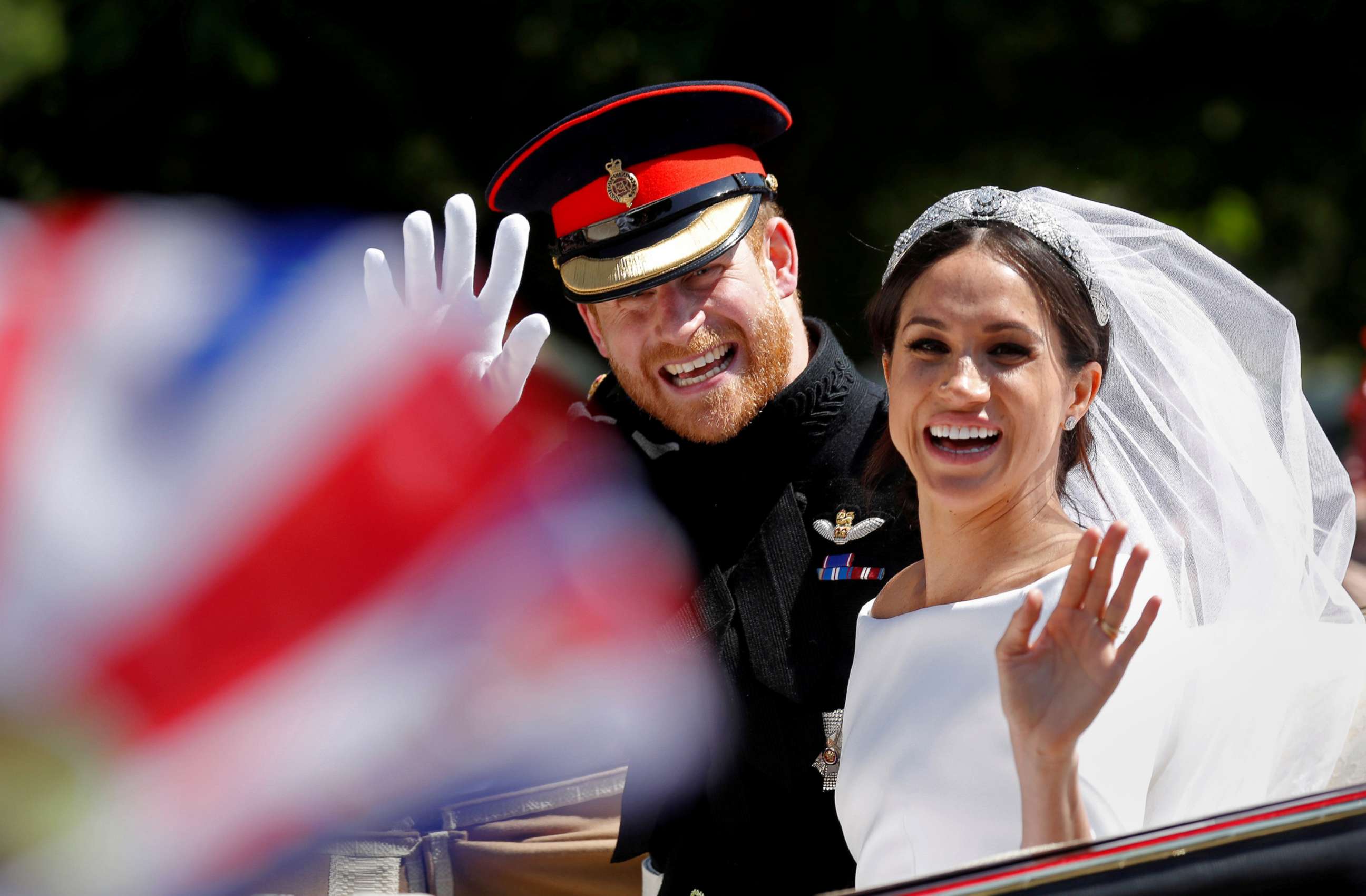 PHOTO: Britain'?s Prince Harry and his wife Meghan wave as they ride a horse-drawn carriage after their wedding ceremony at St George'?s Chapel in Windsor Castle in Windsor, England, May 19, 2018.