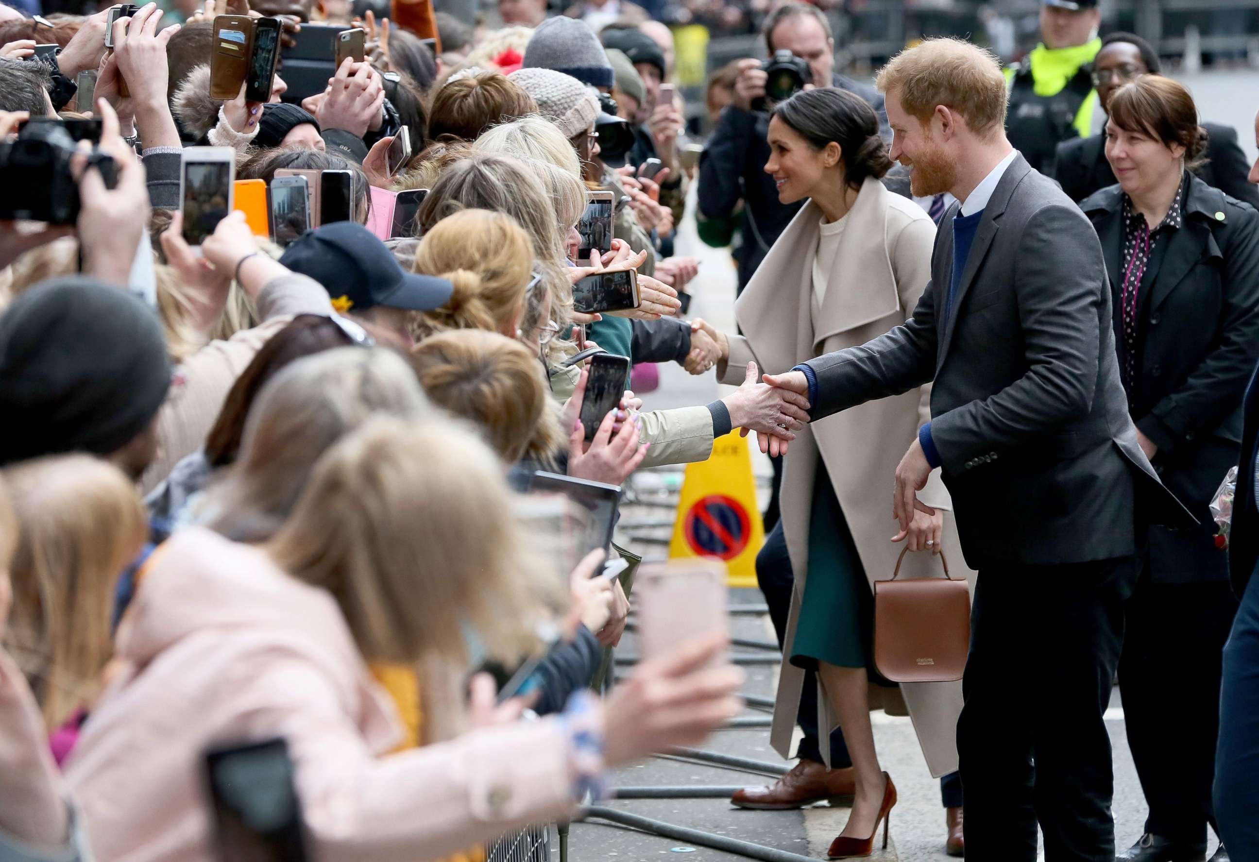 PHOTO: Britain's Prince Harry and Meghan Markle, greet well-wishers after a visit at the historic building, The Crown Liquor Saloon in Belfast, March 23, 2018, where they will learn of the pub's heritage from members of the National Trust.