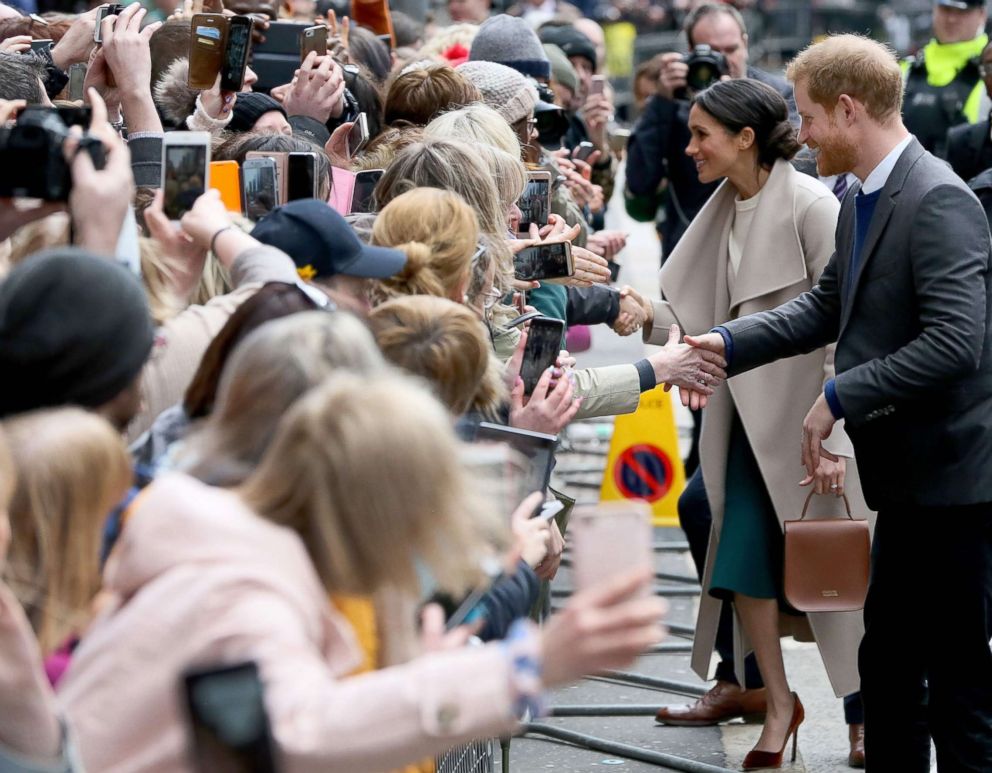 PHOTO: Britain's Prince Harry and Meghan Markle, greet well-wishers after a visit at the historic building, The Crown Liquor Saloon in Belfast, March 23, 2018, where they will learn of the pub's heritage from members of the National Trust.