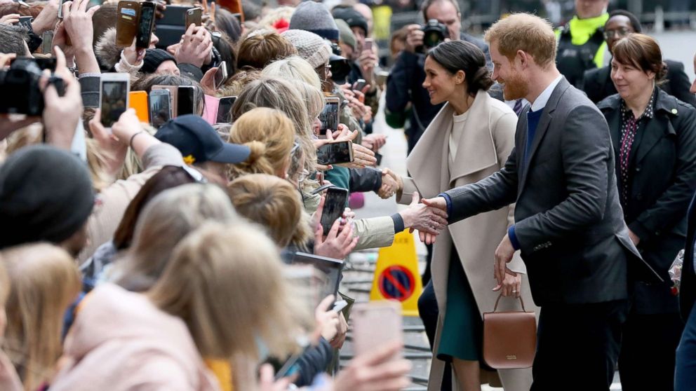 PHOTO: Britain's Prince Harry and his fiancee, Meghan Markle, greet well-wishers after a visit at the historic building, The Crown Liquor Saloon in Belfast, March 23, 2018, where they will learn of the pub's heritage from members of the National Trust.