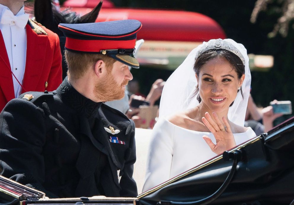 PHOTO: Prince Harry, Duke of Sussex and Meghan, Duchess of Sussex leave Windsor Castle in the Ascot Landau carriage during a procession after getting married at St Georges Chapel on May 19, 2018 in Windsor.