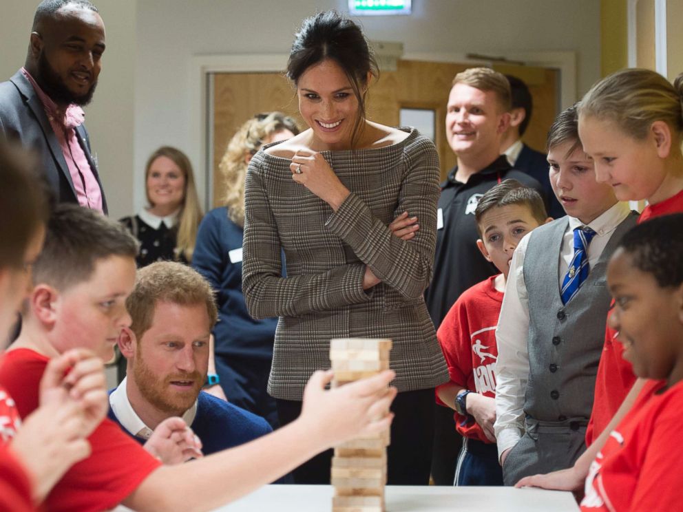 PHOTO: Britains Prince Harry and Meghan Markle reacts as they watch a game of Jenga, during a visit to Star Hub, a community and leisure center in Cardiff, Wales, Jan. 18, 2018.