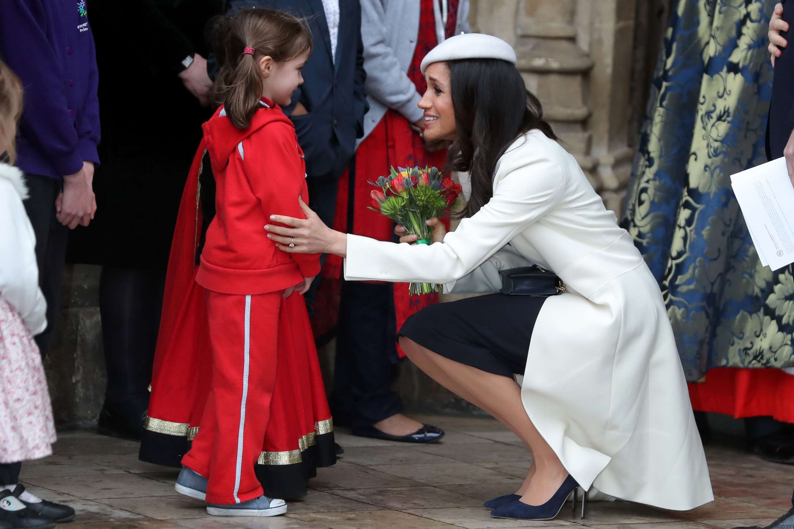 PHOTO: Actress Meghan Markle, fiancee of Britain's Prince Harry, receives a posy of flowers from a young girl after attending a Commonwealth Day Service at Westminster Abbey in central London, March 12, 2018.