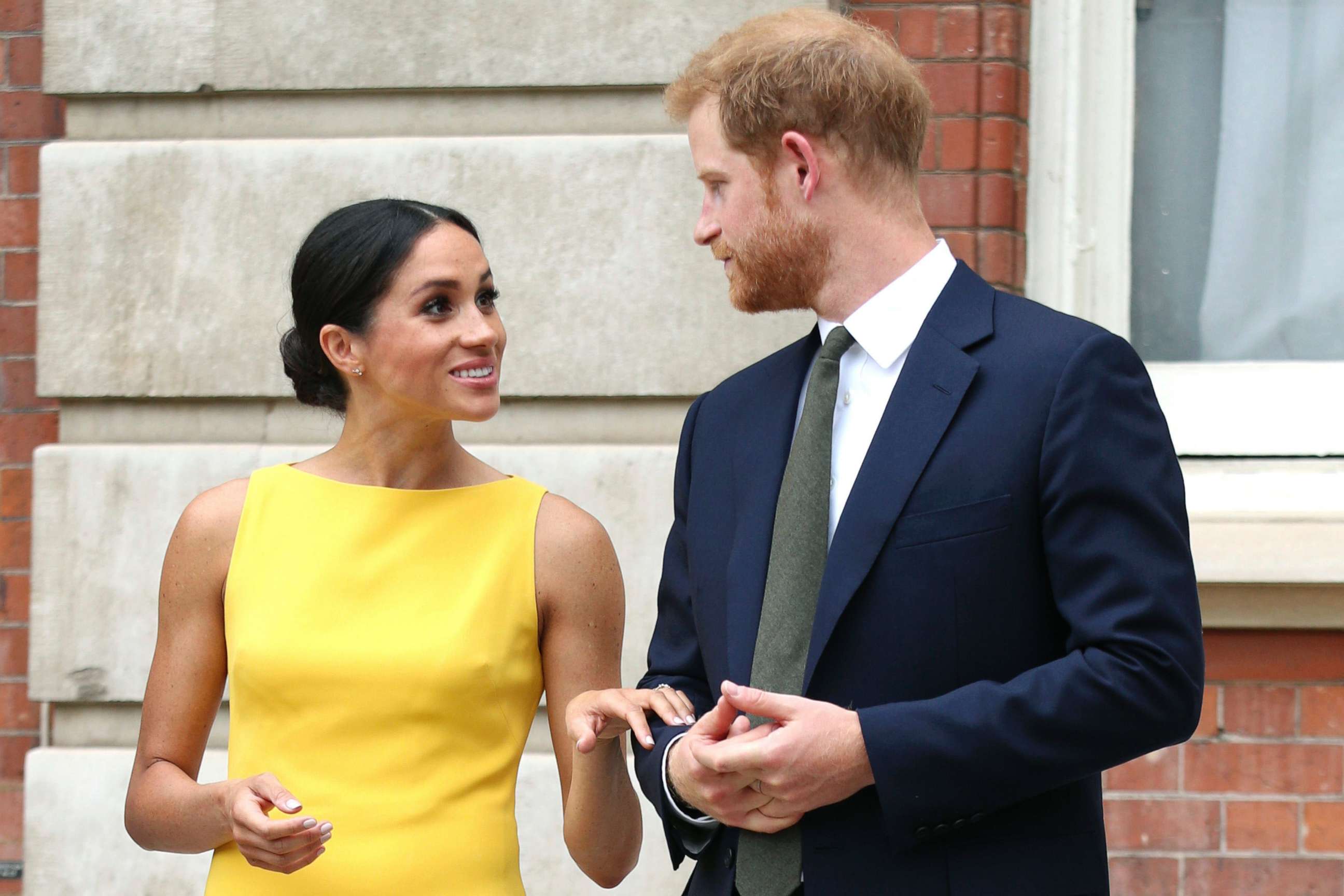 PHOTO: Meghan Markle, the Duchess of Sussex and Britain's Prince Harry, the Duke of Sussex stand as they attend a reception where they will meet youngsters from across the Commonwealth, at Marlborough House in London, July 5, 2018.