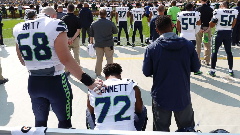 PHOTO: Seattle Seahawks' Michael Bennett remains seated on the bench during the national anthem before an NFL football game against the Green Bay Packers Sunday, Sept. 10, 2017, in Green Bay, Wis.