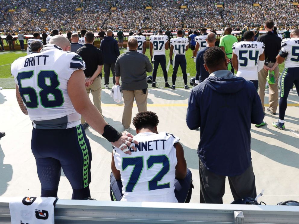 PHOTO: Seattle Seahawks Michael Bennett remains seated on the bench during the national anthem before an NFL football game against the Green Bay Packers Sunday, Sept. 10, 2017, in Green Bay, Wis.