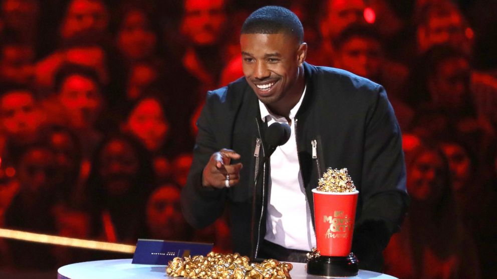 In this Saturday, June 16, 2018, photo, Michael B. Jordan accepts the best villain award for "Black Panther" at the MTV Movie and TV Awards at the Barker Hangar in Santa Monica, Calif.