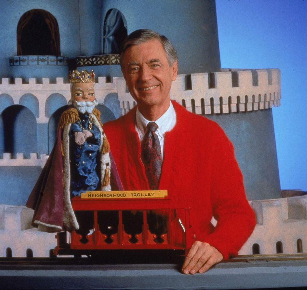 PHOTO: Fred Rogers smiles while posing with a toy trolley on the set of his television show "Mister Rogers' Neighborhood."