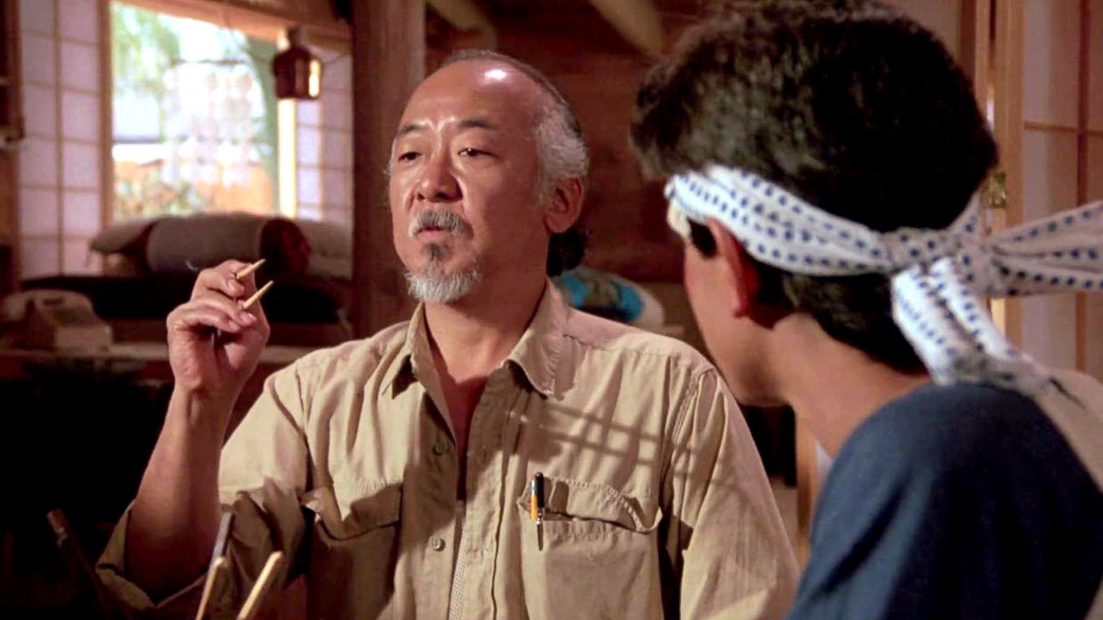 PHOTO: Pat Morita and Ralph Macchio in a scene from the film 'The Karate Kid', 1984