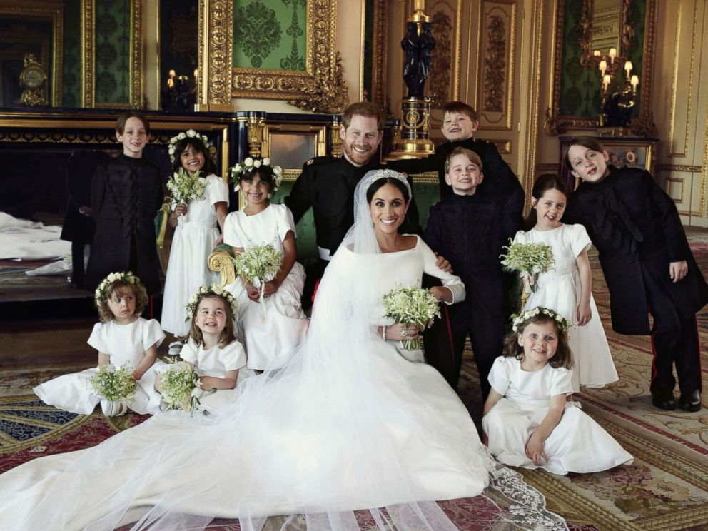 Harry and Meghan smile next to a beaming royal family in official wedding  photos