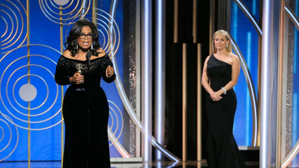 Oprah Winfrey accepts the Cecil B. DeMille Award as presenter Reese Witherspoon looks on, at the 75th Annual Golden Globe Awards in Beverly Hills, Calif., Jan. 7, 2018. 