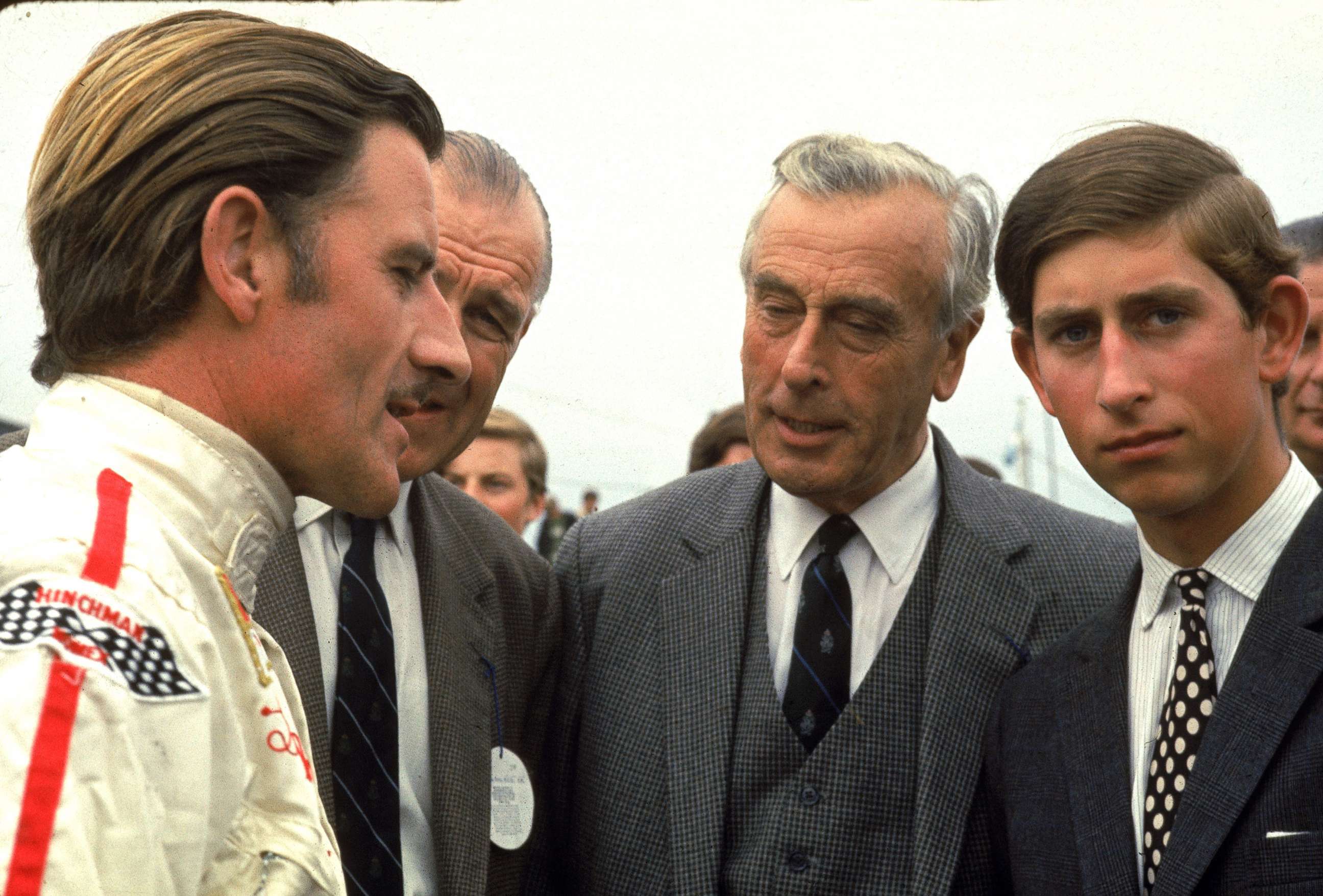 PHOTO: British race car driver Graham Hill talks with Lord Louis Mountbatten and Prince Charles, Prince of Wales, Jan. 1970. 