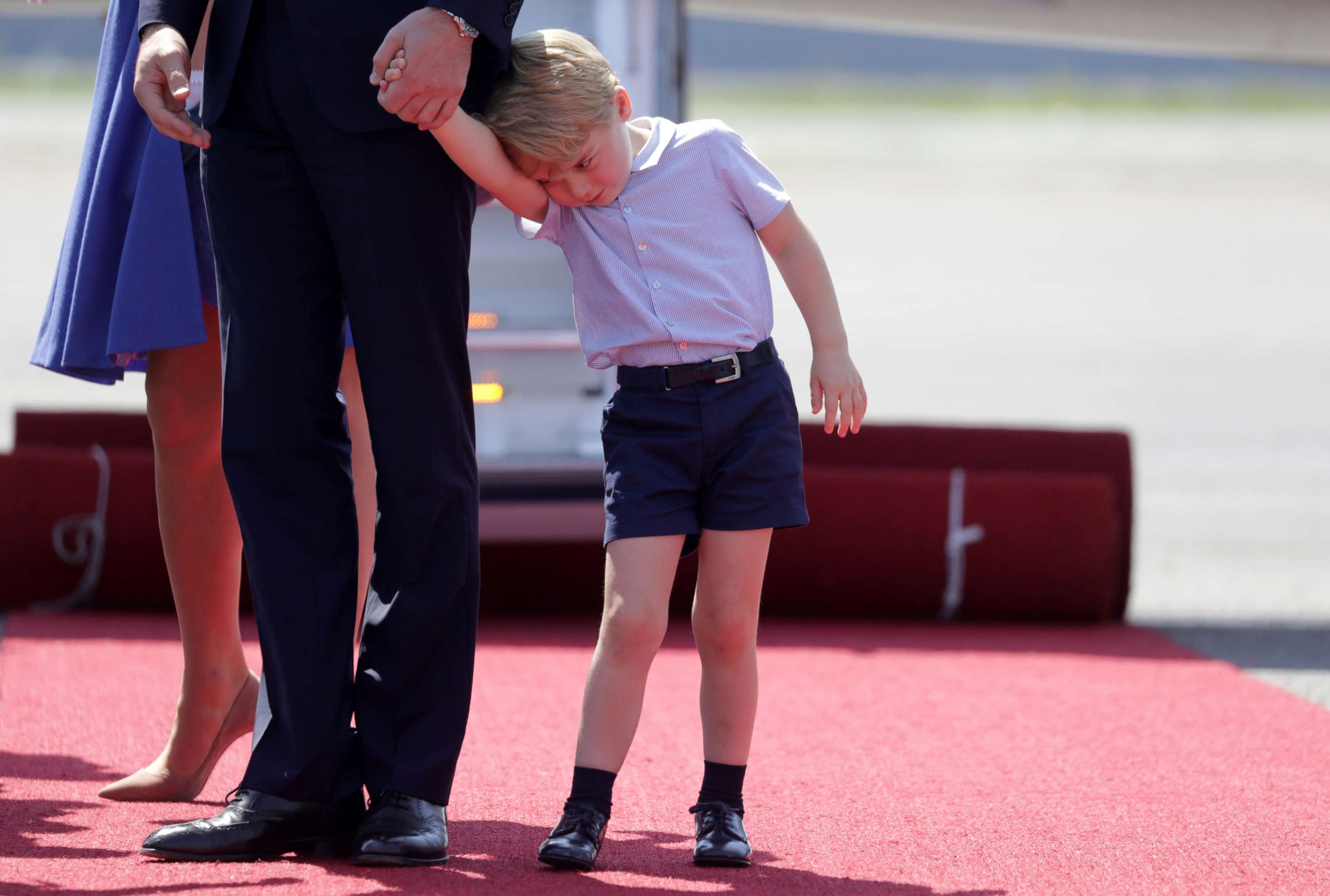 PHOTO: Catherine, The Duchess of Cambridge and Prince William, the Duke of Cambridge and Prince George at Tegel airport in Berlin, July 19, 2017.  