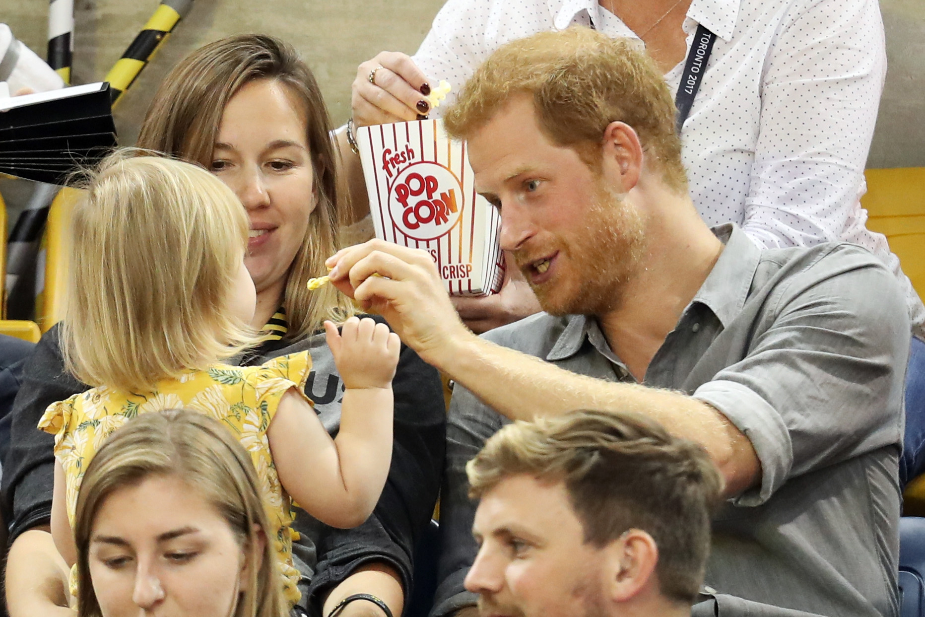 PHOTO: Prince Harry (R) sits with David Henson's wife Hayley Henson (L) and daughter Emily Henson at the Sitting Volleyball Finals during the Invictus Games 2017 at Mattamy Athletic Center, Sept. 27, 2017 in Toronto. 