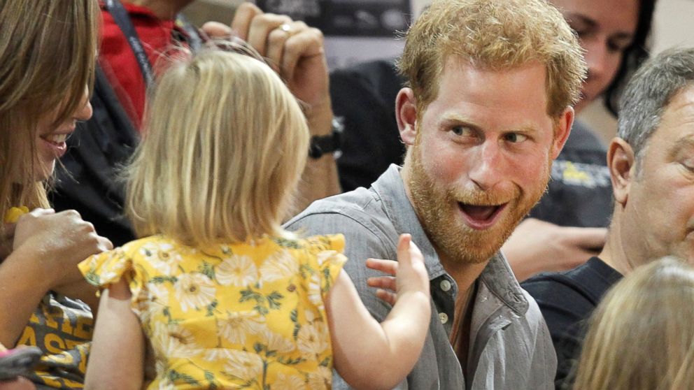 PHOTO: Britain's Prince Harry, patron of the Invictus Games Foundation, shares popcorn with a child while attending the Sitting Volleyball competition at the games in Toronto, Sept. 27, 2017.  