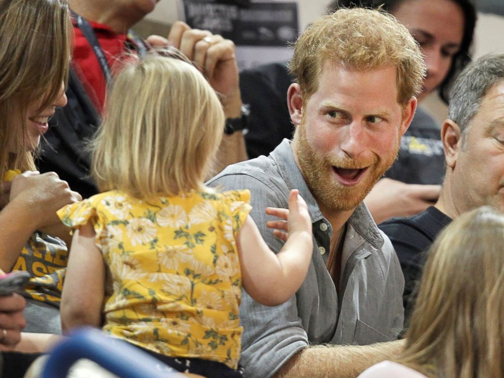 PHOTO: Britain's Prince Harry, patron of the Invictus Games Foundation, shares popcorn with a child while attending the Sitting Volleyball competition at the games in Toronto, Sept. 27, 2017.  