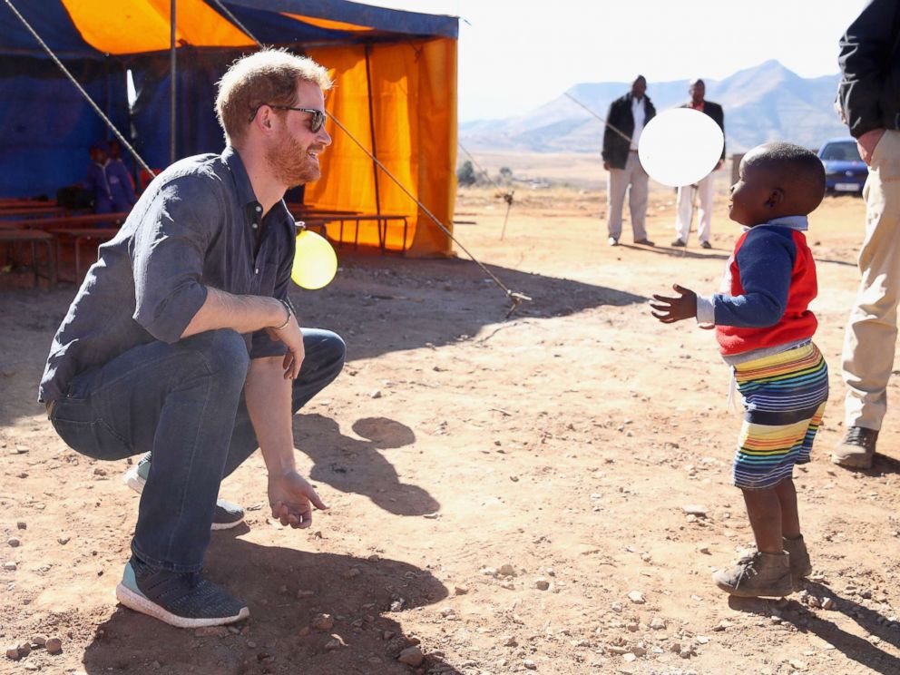 PHOTO: Prince Harry, Duke of Sussex plays with children holding balloons during the official opening of The Dining Hall at Phelisanong Childrens Home on June 23, 2018 in Leribe, Lesotho.
