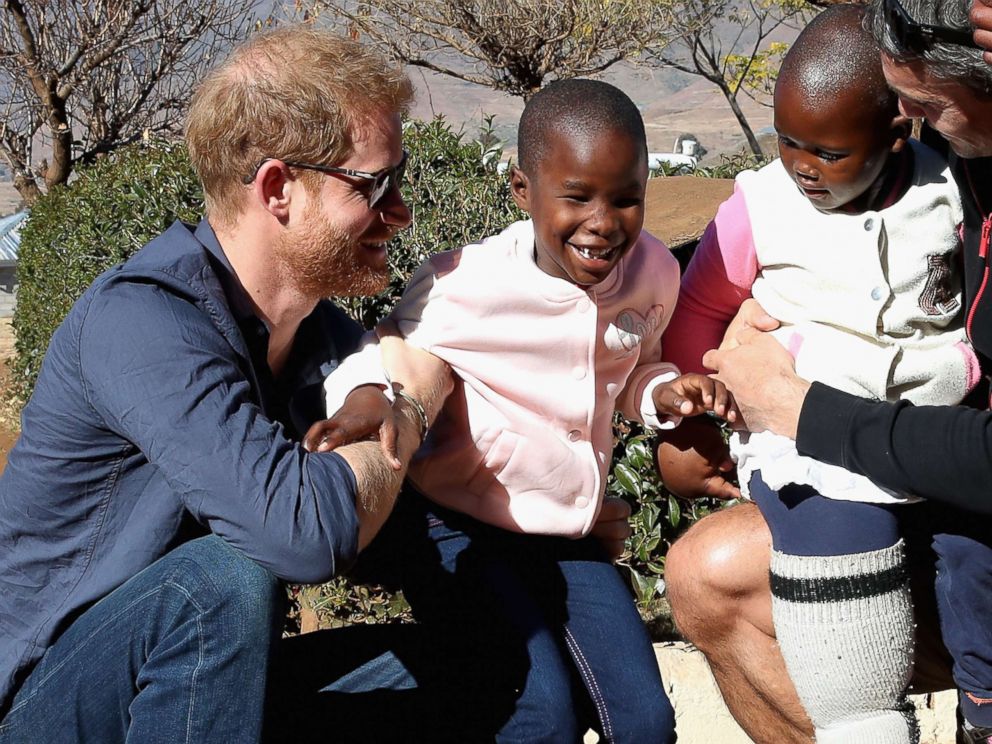 PHOTO: Prince Harry, Duke of Sussex plays with children holding balloons during the official opening of The Dining Hall at Phelisanong Childrens Home on June 23, 2018 in Leribe, Lesotho.
