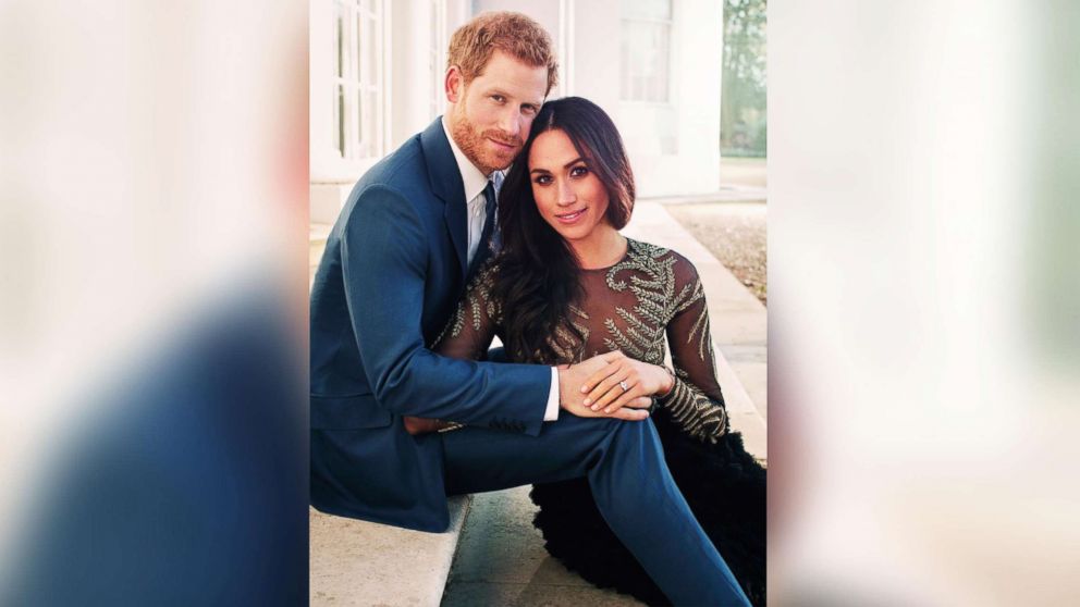 In this photo released by Kensington Palace, Dec. 21, 2017, Britain's Prince Harry and Meghan Markle pose for one of two official engagement photos, at Frogmore House, in Windsor, England.