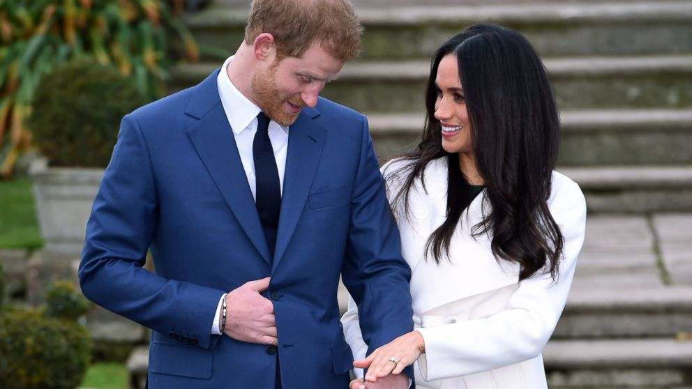 Britain's Prince Harry and Meghan Markle pose for the media in the grounds of Kensington Palace in London, Nov. 27, 2017. It was announced Monday that Prince Harry, fifth in line for the British throne, will marry American actress Meghan Markle in the spring, confirming months of rumors. 