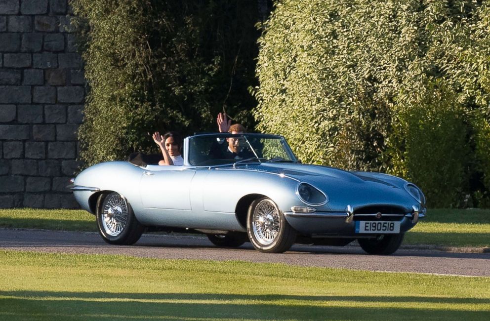 PHOTO: The newly married Duke and Duchess of Sussex, Prince Harry and Meghan Markle wave as they leave Windsor Castle by car to attend their reception in Frogmore House after their royal wedding ceremony in Windsor, England, May 19, 2018.