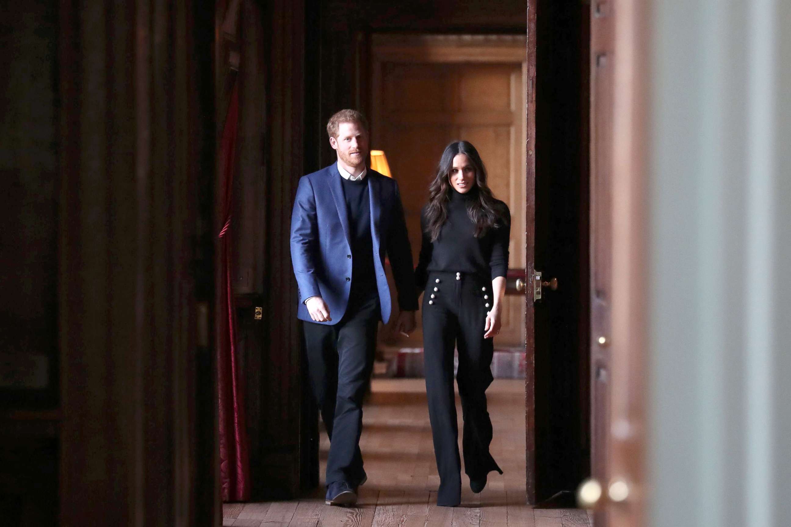 PHOTO: Britain's Prince Harry and his fiance actress Meghan Markle walk through the corridors of the Palace of Holyroodhouse on their way to a reception for young people in Edinburgh, during their visit to Scotland, Feb. 13, 2018.