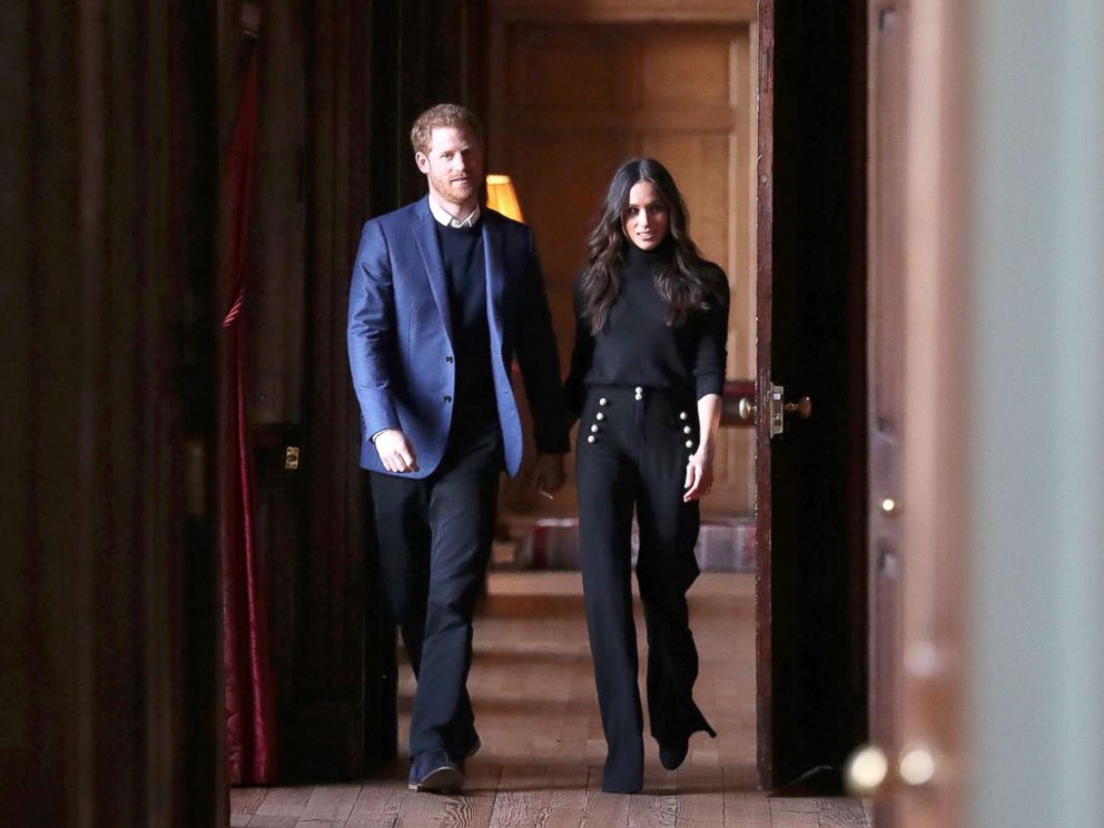 PHOTO: Britains Prince Harry and his fiance actress Meghan Markle walk through the corridors of the Palace of Holyroodhouse on their way to a reception for young people in Edinburgh, during their visit to Scotland, Feb. 13, 2018.