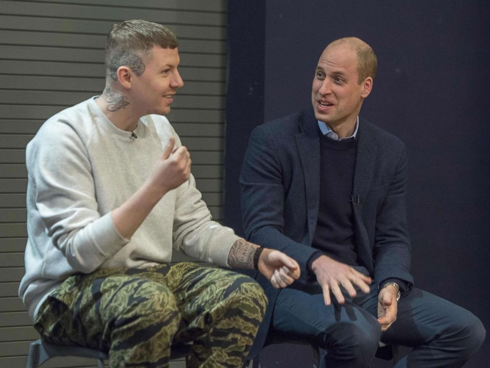 PHOTO: Britain's Prince William, right, accompanied by rapper Stephen Manderson, address students taking part in an assembly on cyber-bullying and its effect on young people's mental health, during their visit to Burlington Academy, London, Feb. 8, 2018.