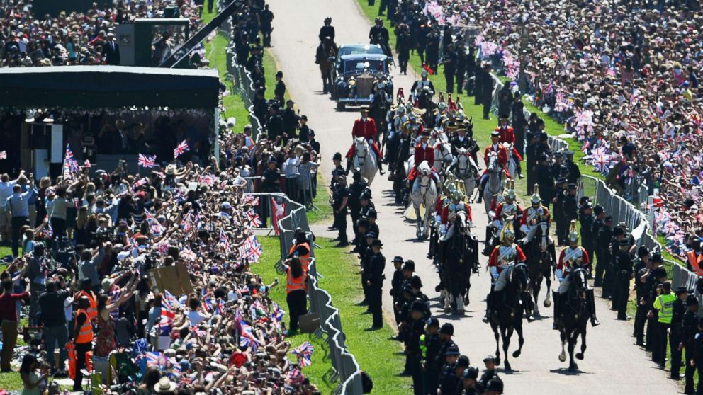 PHOTO: Prince Harry, Duke of Sussex and his wife Meghan, Duchess of Sussex are escorted by members of the Household Cavalry Mounted Regiment during their carriage procession on the Long Walk, May 19, 2018.