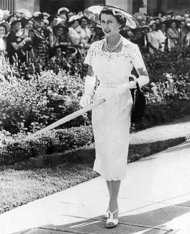 PHOTO: Queen Elizabeth II wears a white lace dress to a garden party in Sydney, February 1954.
