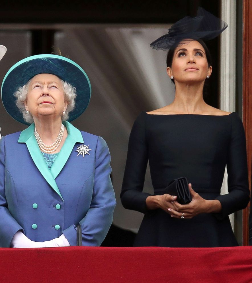 PHOTO: Britain's Queen Elizabeth and Meghan Markle, Duchess of Sussex stand on the balcony of Buckingham Palace as they watch a fly past to mark the centenary of the Royal Air Force in central London, July 10, 2018.