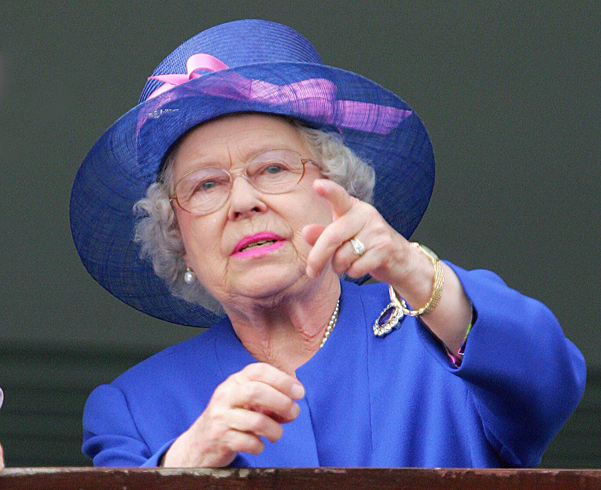 PHOTO: Queen Elizabeth II gestures as Jockey Frankie Detorri crosses the finish line to win the Vodafone Derby at the annual Vodafone Derby horse race at Epsom Downs, Surrey, June 2, 2007.