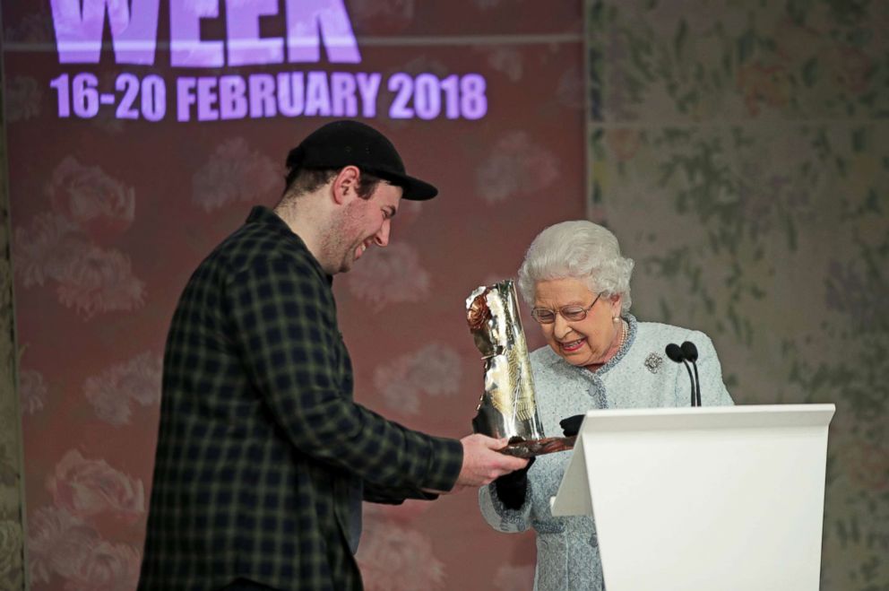 PHOTO: Queen Elizabeth II presents Richard Quinn with the inaugural Queen Elizabeth II Award for British Design, as she visits London Fashion Week's BFC Show Space, Feb. 20, 2018 in London.