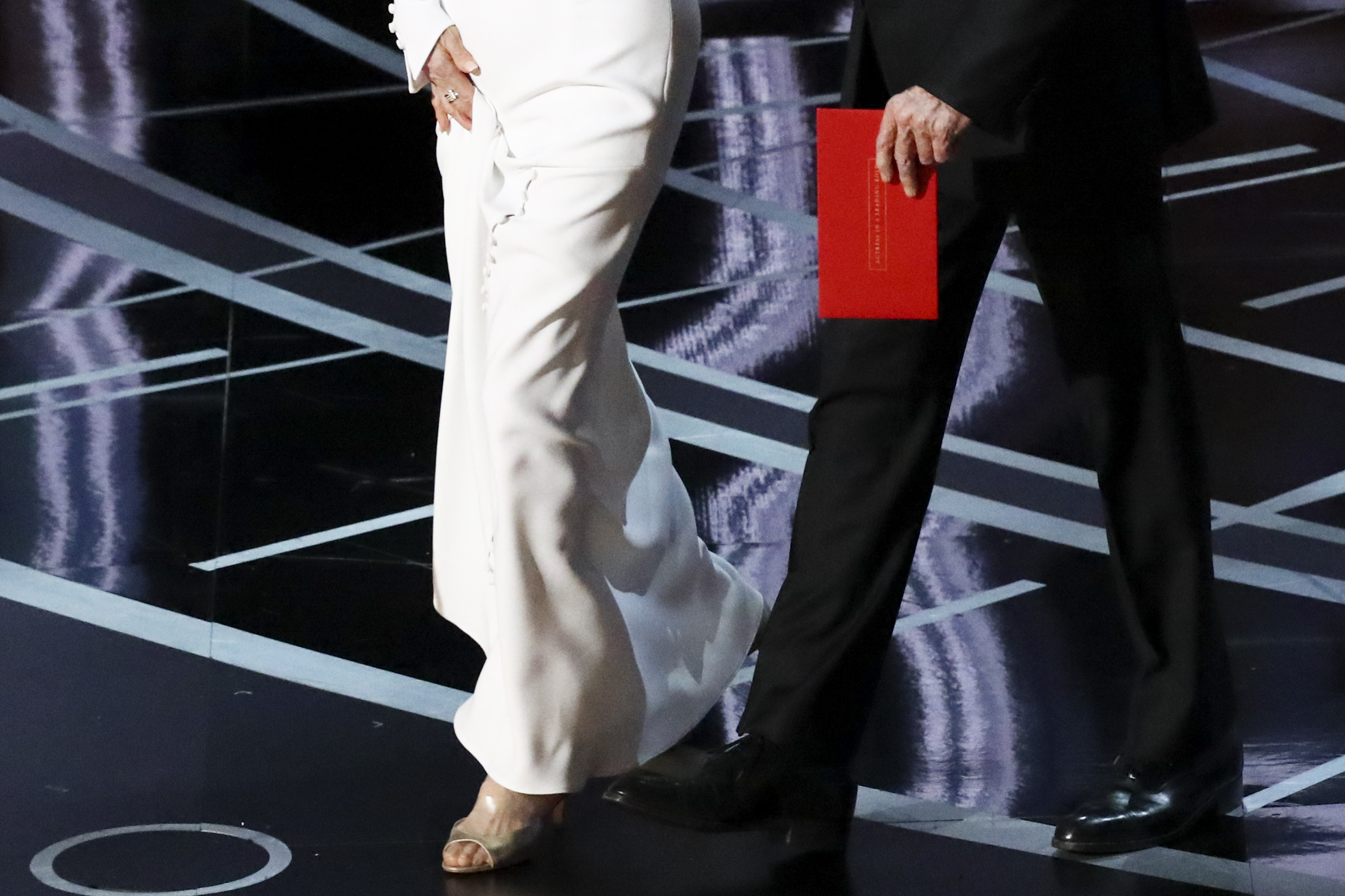PHOTO: Warren Beatty carries an envelope reading "Actress in a Leading Role" as he walks on stage with Faye Dunaway to present the Oscar for Best Picture during the 89th Academy Awards in Los Angeles, Feb. 26, 2017.