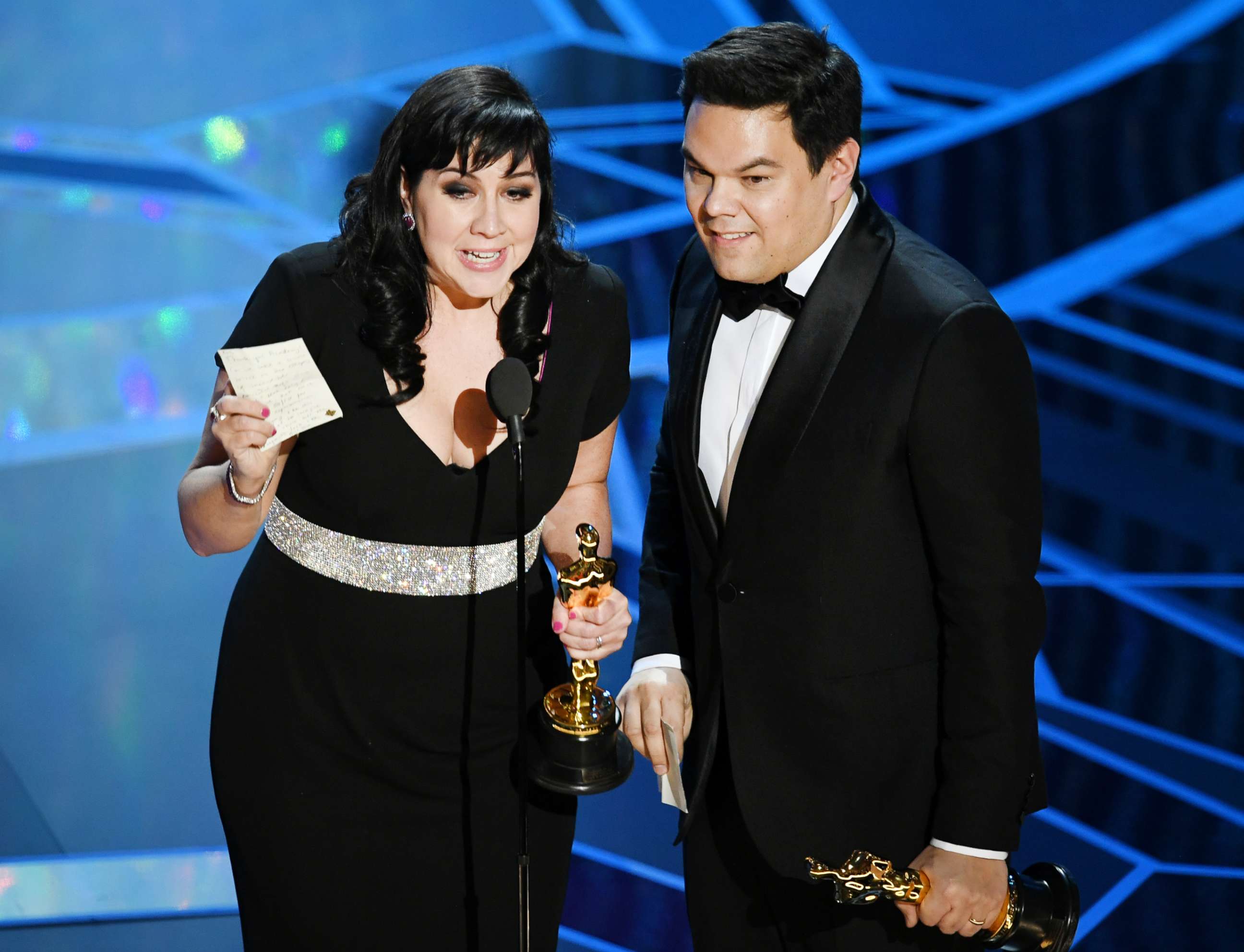 PHOTO: Kristen Anderson-Lopez and Robert Lopez accept best original song award for "Remember Me" from "Coco" during the  Academy Awards on March 4, 2018, in Hollywood, Calif.